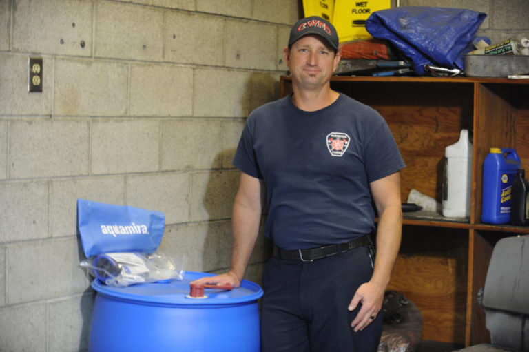 Camas-Washougal Fire Department Captain Michael Brown, standing next to an emergency water barrel with pumps and filters, has taken on the role of natural disaster coordinator for the CWFD. &quot;I have been working hard to get the department prepared for the Cascadia earthquake and any other large scale natural disasters that may come our way,&quot; Brown said.