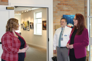 Washington Secretary of State Kim Wyman (right) tours the Second Story Gallery at the Camas Public Library with Camas Library Director Connie Urquhart (left) and Library Support Assistant Christopher Knipes (center),  on Tuesday, Sept. 19. 