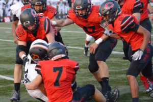 Camas defenders Taylor Adams (7), Tristan Souza (55), Caleb Field (89), Luke Bruno (17), Sam Malychewski (9) and Isaiah Abdual (2) work together to bring down 275-pound Mason Dominguez of AC Davis Friday, at Doc Harris Stadium. The Papermakers defeated the Pirates 52-19. 