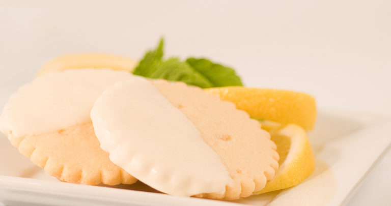 McTavish Shortbread employees cut and dip the traditional shortbread cookies by hand at the company&#039;s Portland-based bakery.