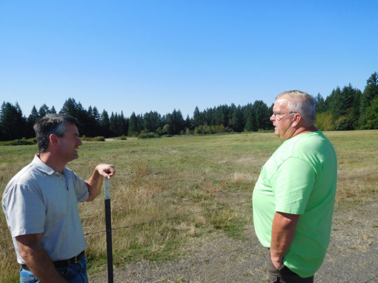 Port of Camas-Washougal Commissioner John Spencer (left) and DOGPAW Operations Manager Mark Watson (right) discuss a potential partnership -- involving the port, DOGPAW, Clark County and the cities of Camas and Washougal -- for a new dog park next to the Camas-area Grove Field Airport.