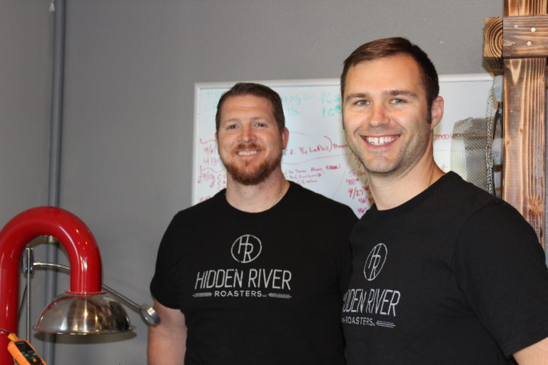Brandon Pasa (left) and Aaron Baldwin (right) stand next to their coffee roaster, which is capable of producing five-pound batches of micro-roasted coffee. The two men founded Hidden River Roasters last year and are now opening a cafe with East Clark County’s first on-site coffee roastery in downtown Camas.