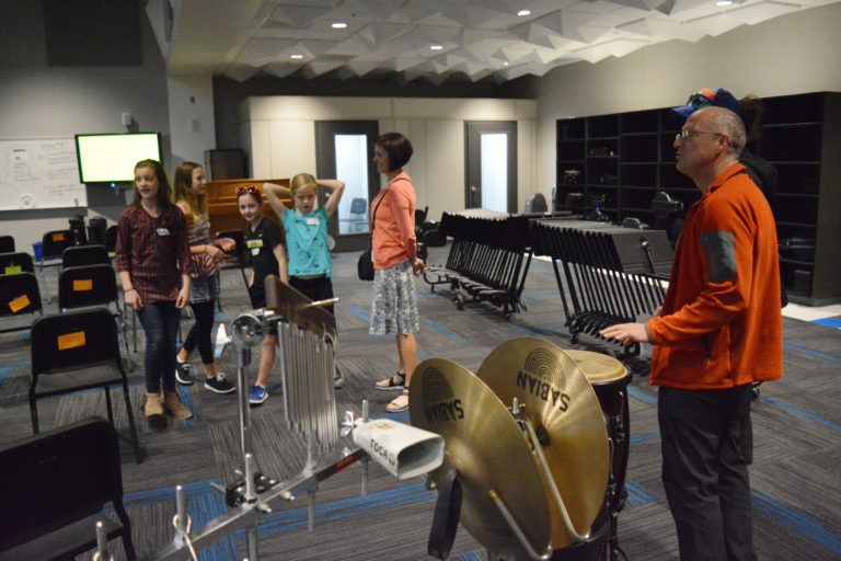 Visitors test out the instruments in the music room at Jemegaard Middle School during the Open House.