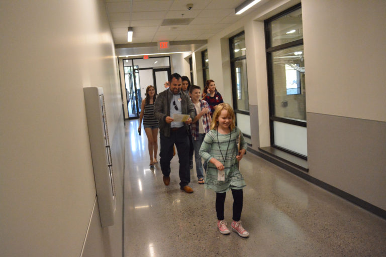 Columbia River Gorge Elementary student ambassador Emerson Fletcher leads a tour group down the hall during the Oct.