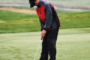 Owen Huntington sinks his par putt for Camas on the 17th hole Tuesday, at the Tri-Mountain Golf Course in Ridgefield. The freshman finished in fifth place at districts, with a two-day total of 150, to advance to the bi-district tournament in May. He improved his score by four strokes in the final round.