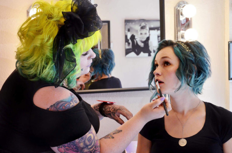 Miranda Straub, owner of mandi MOON artistry, applies lipstick on her best friend and sister, Rachael Gunderson. Straub and Gunderson work at The Wild Hair salon, owned by their mother, Jyl Straub, in downtown Camas. Miranda graduated from Cedars&#039;s Academy of Makeup Artistry, in Vancouver, in August 2017.