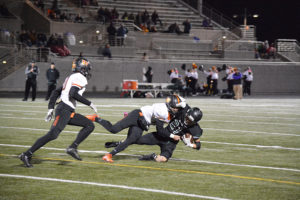 Washougal's Ryan Stevens chops down Woodland's Tyler Flanagan for a loss of eight yards during the 2A Greater St. Helens tiebreaker Monday, at Doc Harris Stadium. Columbia River defeated Woodland and Washougal for the No. 2 playoff seed. Woodland took the No. 3 seed and Washougal settled for No. 4.