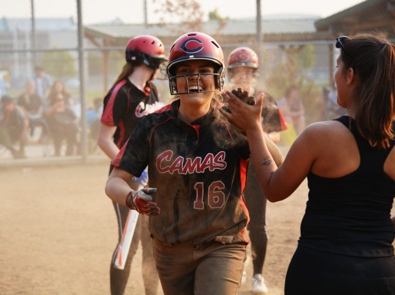 Megan Bauer is all smiles after scoring the tying run for the Papermakers Sept. 14, at Skyview High School.