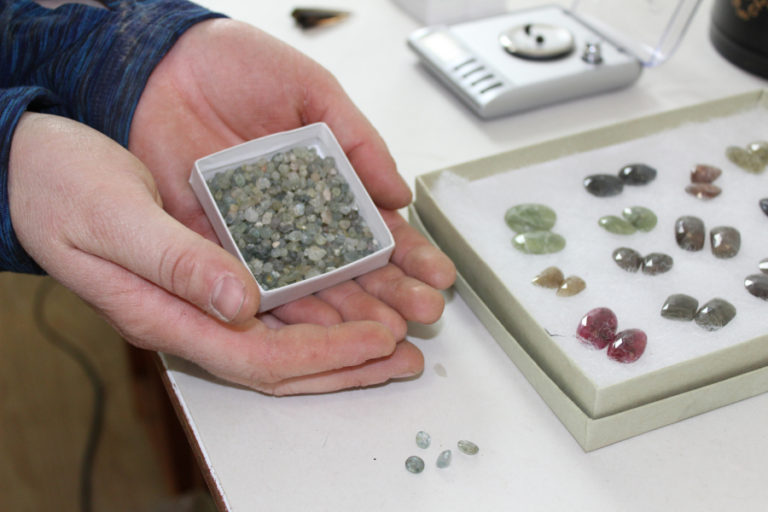 Megan McGaffigan, an artist taking part in the fifth annual Clark County Open Studios tour this weekend, holds a box of uncut Montana sapphires she mined herself.