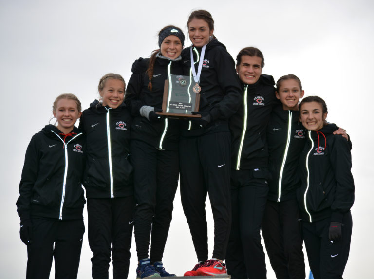 The Camas High School girls cross country team stands on the podium in second place at the 4A state meet Saturday, on the Sun Willows Golf Course, in Pasco.