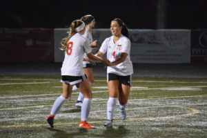 Maddie Kemp (4) celebrates her 82nd career goal on Jazzy Paulson's 16th assist this season Thursday, at Doc Harris Stadium. Those are both new records for the Camas High School girls soccer program. The Papermakers defeated Todd Beamer, of Federal Way, 9-0 to punch their ticket to the state tournament.