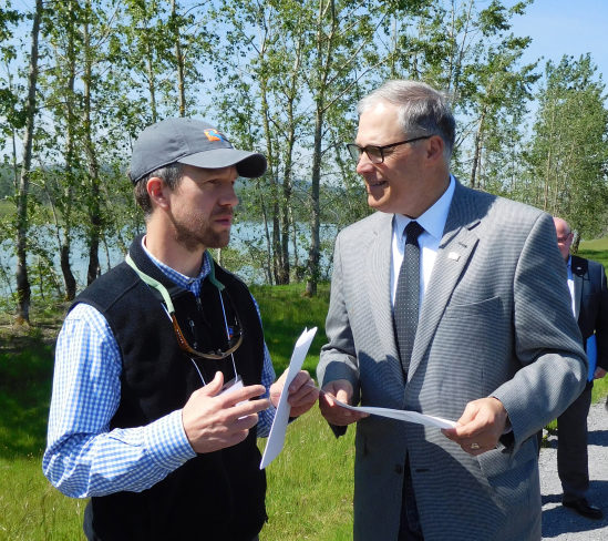 Washington Governor Jay Inslee (right) met with Chris Collins (left), principal restoration ecologist with the Lower Columbia Estuary Partnership in May of 2017, to discuss a habitat restoration and flood-control project at Steigerwald Lake National Wildlife Refuge near Washougal. The plan to reconfigure the Port of Camas-Washougalis levee system is expected to remove a section of the levee where some deficiencies have been noted by the U.S. Army Corps of Engineers.