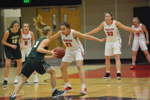 Camas defenders Marianna Payne (front and center), Courtney Clemmer (right), Hailey Hanson and Jillian Webb (background, left) make sure there is no entry for Jesuit. The Papermakers rallied to defeat the Crusaders, 40-38, for their first victory of the season. 