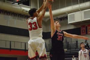 Tre Carlisle shoots the basketball over Zachary Chilian during a scrimmage game in the Papermaker Warehouse. Carlisle has high expectations for Camas this season. "Everybody -- from the crowd to the guys on the bench to the players on the floor -- we're all one." 