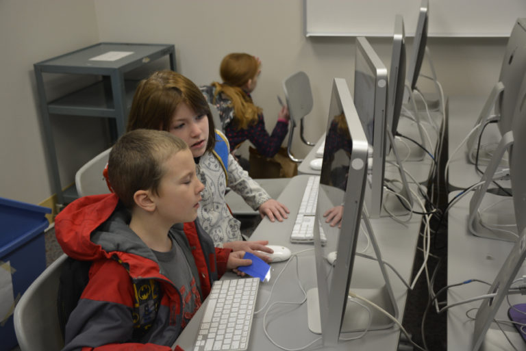 Hathaway Elementary students Jason Burden, a first-grader, (left) and Virginia Burden, in fourth grade (middle) learn about computer science language in a recent &quot;Hour of Code&quot; event held at the Washougal elementary school.