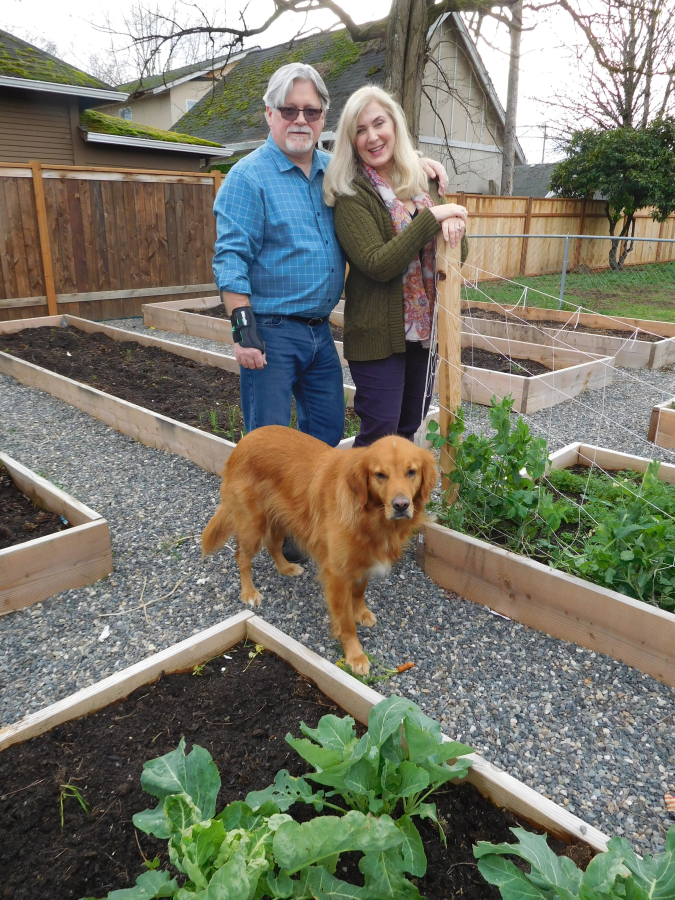 Dave and Deanna DePonceau, and their dog, Sophie, enjoy spending time in the garden behind their Deponceau &amp; Associates office.