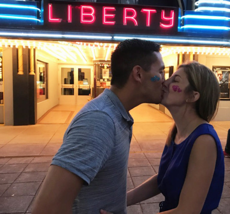Nick Calais and Tami Weidert, Camas First Friday ambassadors, share a kiss in front of Liberty Theatre, where they will be married by Camas Mayor Scott Higgins on Friday, Feb. 2.