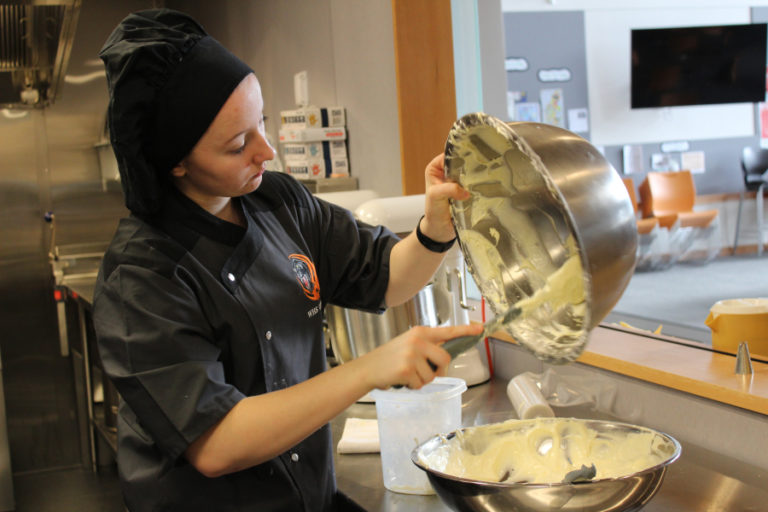 Washougal High School sophomore Alexis Garrett combines the tiramisu custards while clearning up after her advanced culinary class at Excelsior High School.