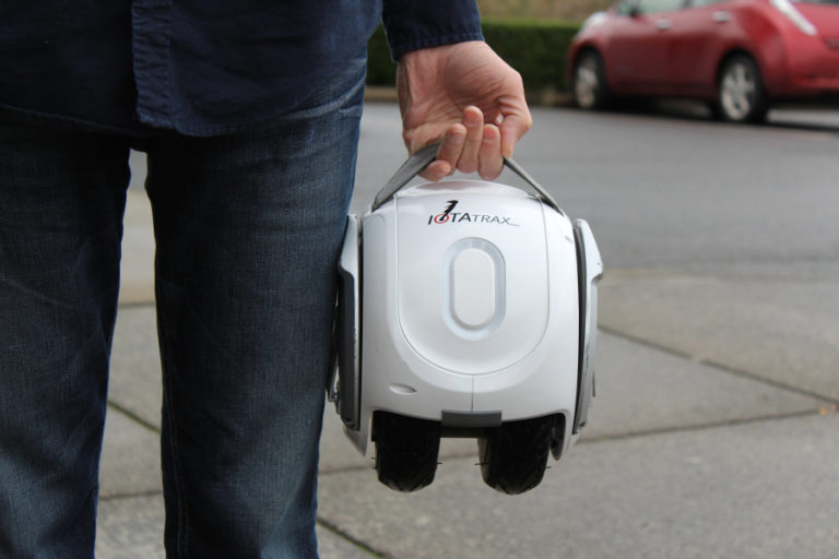Camas inventor Shane Chen holds his latest invention, the IOTAtrax, a 15-pound, portable, electric-powered, self-balancing gadget that holds a person weighing 200 pounds or less, goes up to eight miles on a charge, at speeds of up to 10 mph, and recharges in about an hour.