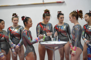 Members of the Camas High School gymnastics team get ready to compete on the bars at Naydenov Gymnastics Center, in Vancouver. Camas scored a program best 174.5 points to defeat Columbia River, Heritage and Union in the second meet of the season. 