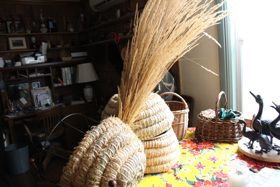 Susan McElroy-Knilans makes her own skeps out of tall grass straw that she cuts down from nearby parks.