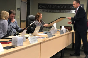 Camas School District Superintendent Jeff Snell presents former Camas School Board members Casey O'Dell and Julie Rotz a gift during their last board meeting, Monday, Feb. 12. The two school board positions are open and applications will be accepted by Gail Gast online or in person until noon on Friday, March 2. 