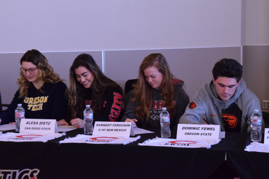 Courtney Clemmer, basketball; Alexa Dietz, rowing; Kennedy Ferguson, softball and Dominic Fewel, soccer sign their letters of intent during a ceremony at Camas High School on Wednesday. (Photo courtesy of Rene Carroll)