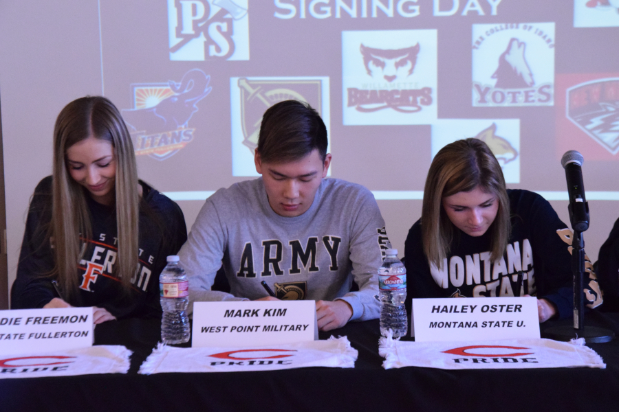 ABOVE: Madison Freemon, basketball; Mark Kim, swimming and Hailey Oster sign their letters of intent at Camas High School on Wednesday, Feb. 7.