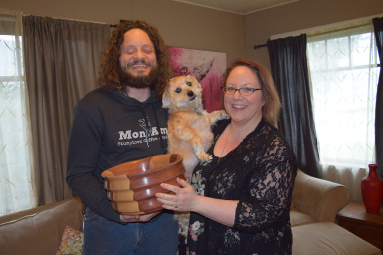John Furniss, Pickle Furniss and Anni Becker Furniss are pictured with a bowl made out of the heavy woods ash and bubinga wood that John made.