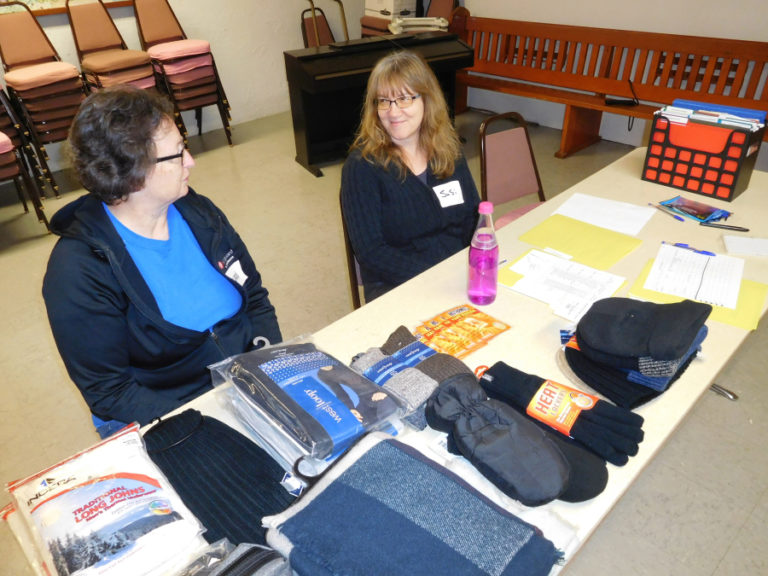 Vickie Cable (left) and Susi Lantz (right) volunteer in a severe weather shelter Thursday, Feb. 22, at St. Matthew Lutheran Church, in Washougal. Volunteers go through training and background checks before helping at the shelter.