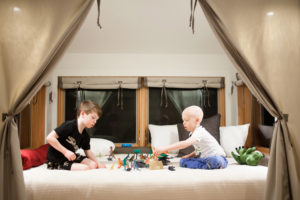Declan Reagan (right) and his twin brother, Adrian, enjoy playing with dinosaur toys in a treehouse at Skamania Lodge, in Stevenson. They stayed with their parents, Washougal Police Officer Francis Reagan and Lauren Reagan, in the treehouse in January, after Declan, 5, was released from the hospital with a terminal cancer diagnosis. "Making fun memories is one of our top priorities for our little dinosaur," Lauren said. (Contributed photos courtesy of the Reagan family)