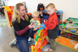 Shannon Gruelle watches her son, Skyler, 4, play with toy cars, while she holds Lincoln Clifford, 13 months, at her new business, Get it out! Genuine Play, located in the Evergreen Marketplace, in Washougal. Gruelle opened the child play space and drop-in child care facility in December of 2017. She will offer half-day and full-day preschool, starting in April.