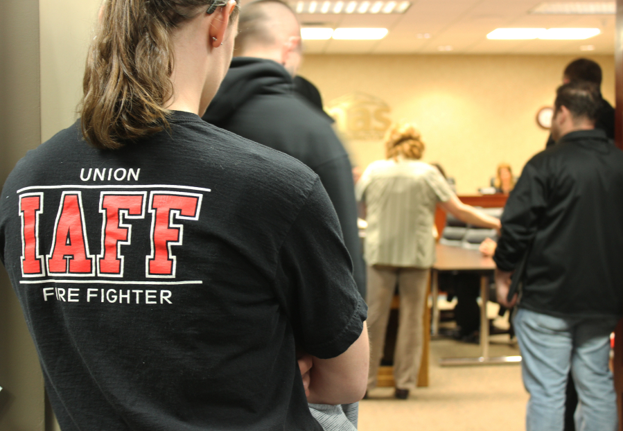 Members of the local International Association of Fire Fighters union stand in the hallway of Camas City Hall on Monday, March 19, at a Camas City Council meeting.