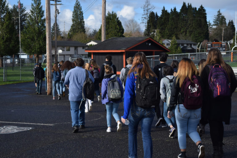 Washougal High School students head toward Fishback Stadium for a walkout they said was in honor of the Florida school shooting victims, but was &quot;not political.&quot;