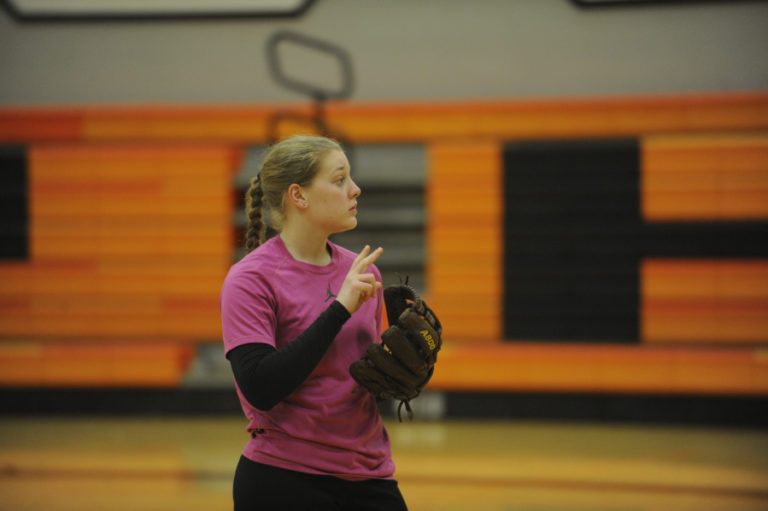 Washougal pitcher Hailey Froeber takes direction from her injured teammate Paige Forsberg (not pictured) on a rainy day, inside the Washougal High School gym.