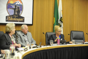 Washougal City Councilman Ray Kutch (center) sits with Mayor Molly Coston (left) and Councilwoman Julie Russell (right) at a 2018 city council meeting. (Post-Record file photo) 