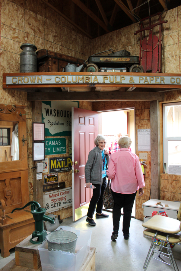 Camas-Washougal Historical Society President Jim Cobb (back),  Vice President Alma Jemtegaard Ladd (left) and founding member Bernice Pluchos (right), exit the &quot;Tool Shed&quot; at the Two Rivers Heritage Museum in Washougal.