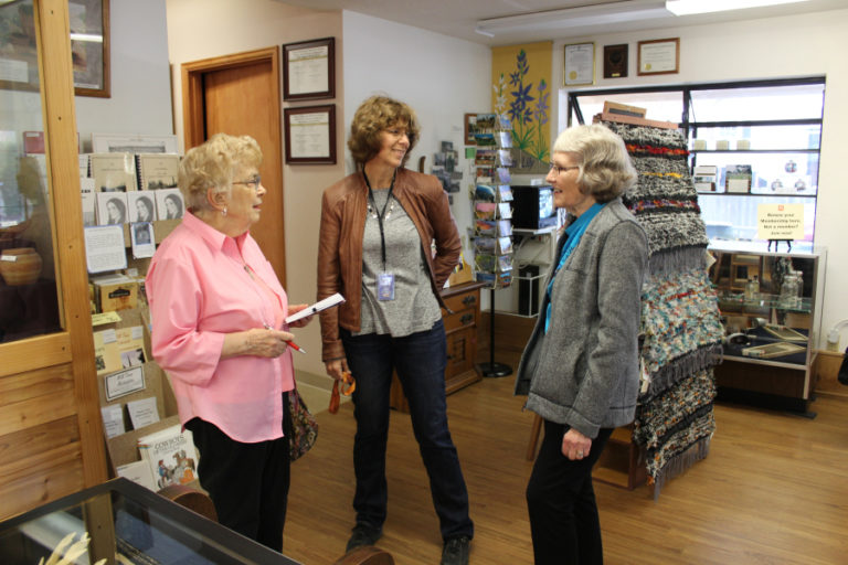 Bernice Pluchos, a founding member of the Camas-Washougal Historical Society (left) and the society&#039;s vice president, Alma Jemtegaard Ladd (right), talk to historical society volunteer and publicist Rene Carroll (center) inside the gift shop of the Two Rivers Heritage Museum.