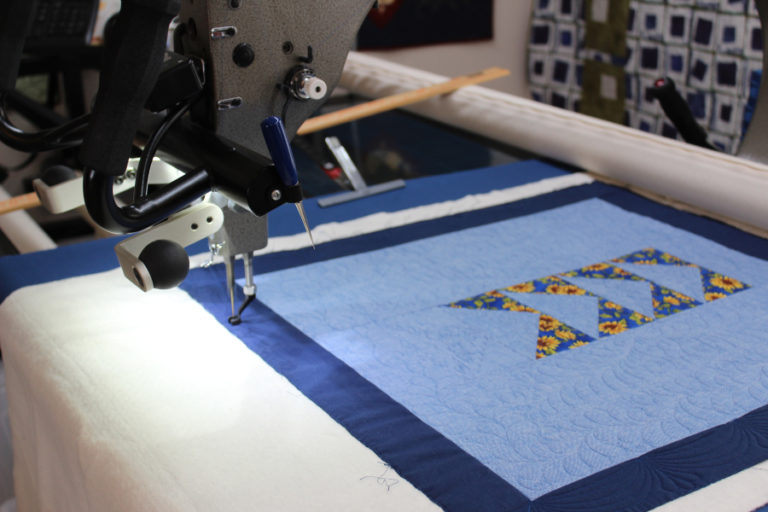 Camas quilter DeAnn Perrigo&#039;s 14-foot-long long-arm quilting machine quilts Perrigo&#039;s &quot;Flying Geese&quot; quilt. The quilt will be one of two Perrigo enters in the upcoming Clark County Quilters&#039; 43rd annual Quilt Show, which begins at 10 a.m., Thursday, April 5 and runs through Saturday, April 7, at the Clark County Event Center in Ridgefield.