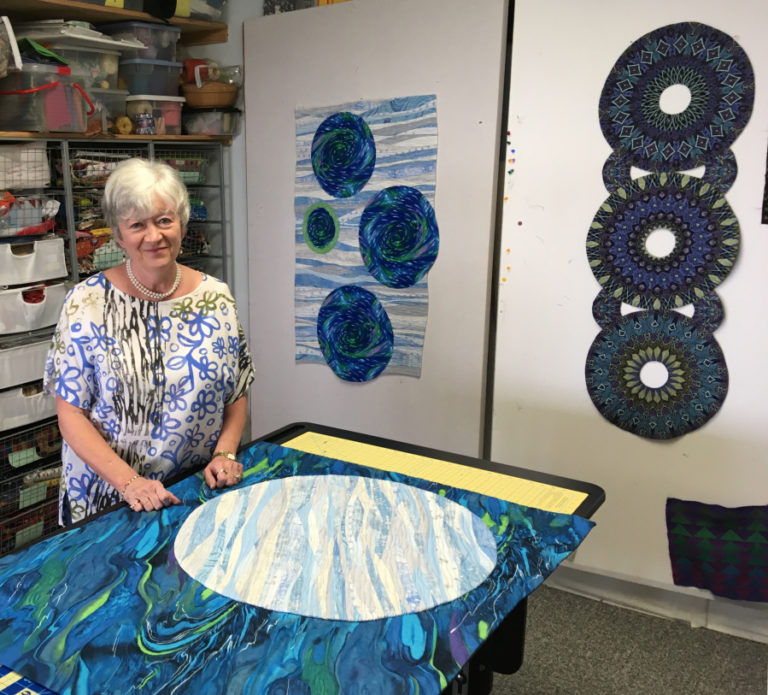 Camas quilter Dianne Kane stands in her studio, near two of her art quilts. The quilt on the left is called &quot;Moons Over my Bathtub,&quot; and is one of seven quilts Kane will show in the upcoming Clark County Quilters&#039; 43rd annual Quilt Show, April 5-7, at the Clark County Event Center. Kane, along with another local quilter, Wilma Scott, is co-chair of this year&#039;s quilt show.