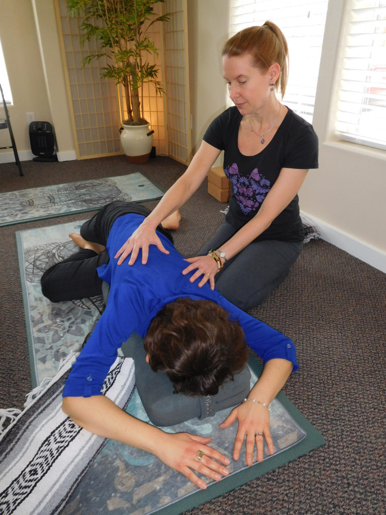 (Dawn Feldhaus/Post-Record)
Moriah Diederich, a holistic yoga therapist, guides Sarah Coomber through a relaxing restorative yoga pose at Yoga Mojo, in East Vancouver. Diederich, of Camas, said the restorative pose can help calm the nervous system, aid in digestion and contribute to an overall feeling of peace.
