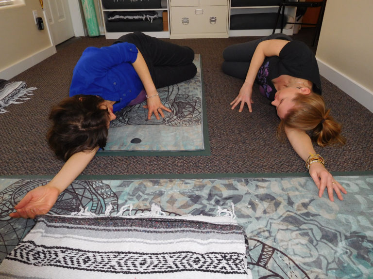 (Dawn Feldhaus/Post-Record)
Holistic Yoga Therapist Moriah Diederich (right), owner of Yoga Mojo, shows client Sarah Coomber (left), a self-care technique to help release tension in the lower back and alleviate pain. Diederich, of Camas, opened Yoga Mojo in January of 2018.