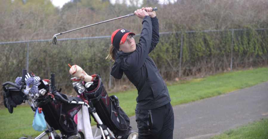 Camas junior Emma Cox takes a full swing in wet conditions at the Titan Cup at Tri Mountain Golf Course in Ridgefield on Monday, April 16.