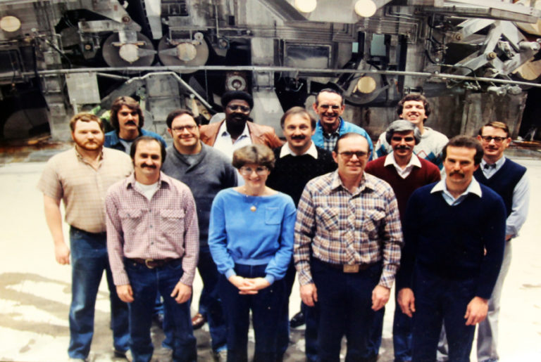 Camas mill worker Kraig Nichols (left, front row), stands with members of the original start up crew for machine No. 20 in 1984. The office paper machine, which produces 3,000 feet of paper per minute, will shut down on May 1.