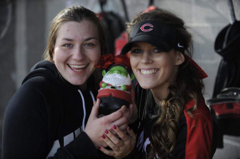 Camas softball players Kyli Obermiller and Payton Bates show off the team gnome at their home field on April 18.