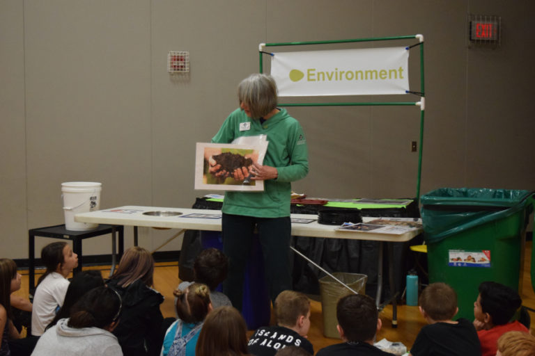 Ellen Ives, educator for sustainability and waste reduction from Waste Connections, talks to Hathaway Elementary students about composting and recycling during the April 20 Well-Being Fair at Hathaway.