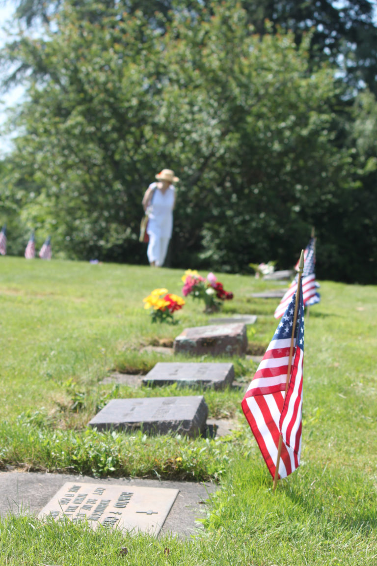 Small flags are placed on veterans’ graves in the Washougal Memorial Cemetery, in 2016.