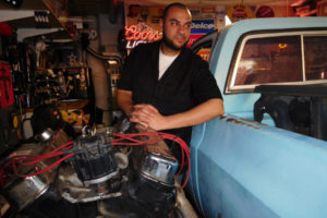 Jon Corral leans on a 1978 GMC heavy half square body pickup in his Washougal garage. He is restoring the vehicle and will replace its engine with one from a newer pickup. 