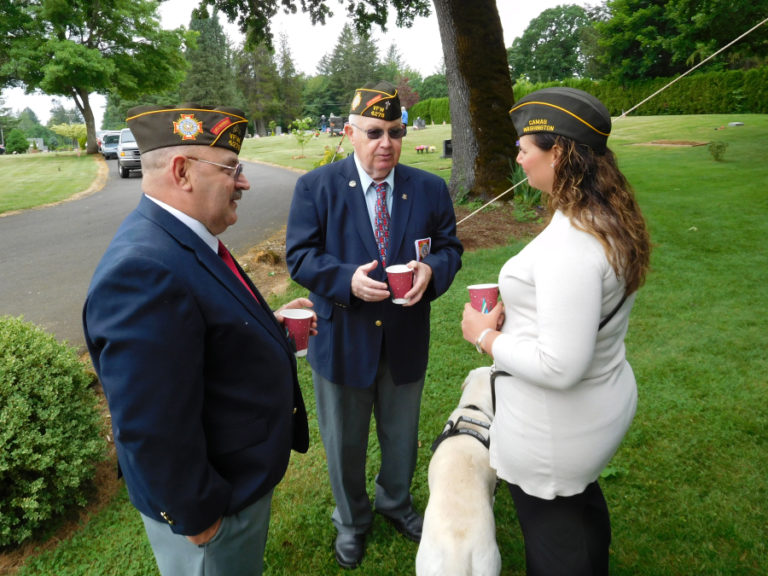 Veterans of Foreign Wars Post 4278 members Jerry Haxby, Chuck Farrell and Sarah Aktepy, accompanied by her service dog, Violet, (from left to right) enjoy refreshments after participating in a Memorial Day ceremony, Saturday, May 26, at the Fern Prairie Cemetery. Memorial Day ceremonies were also held Monday, May 28, at the Camas and Washougal cemeteries.