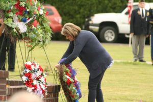 A woman leaves a wreath at a Memorial Day event at Washougal Cemetery on Monday, May 28, to commemorate fallen military members. 